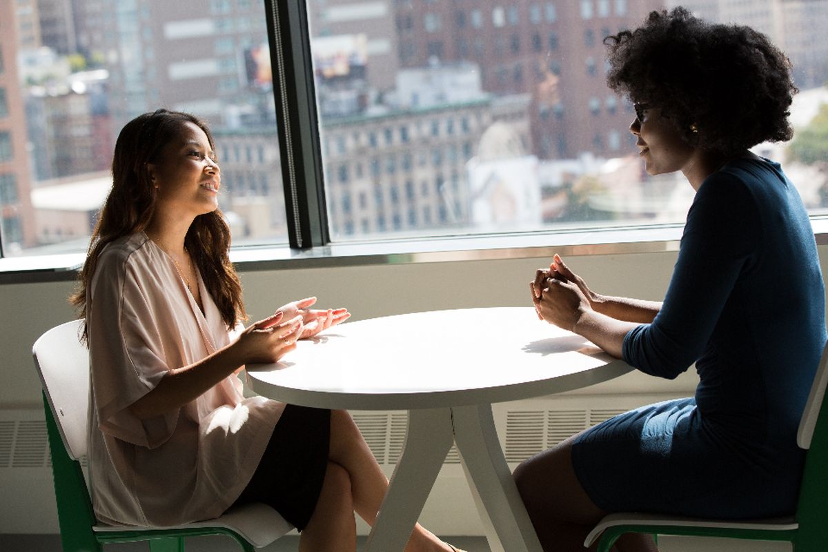 Two people sitting together in warm conversation